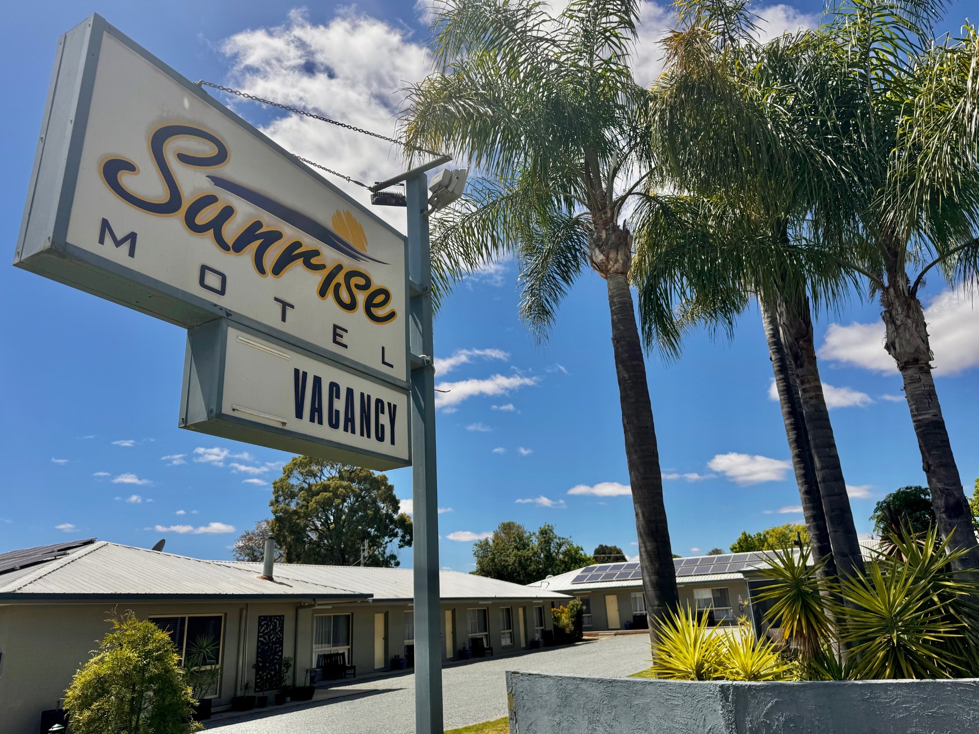 welcome to sunrise motel sign and entrance