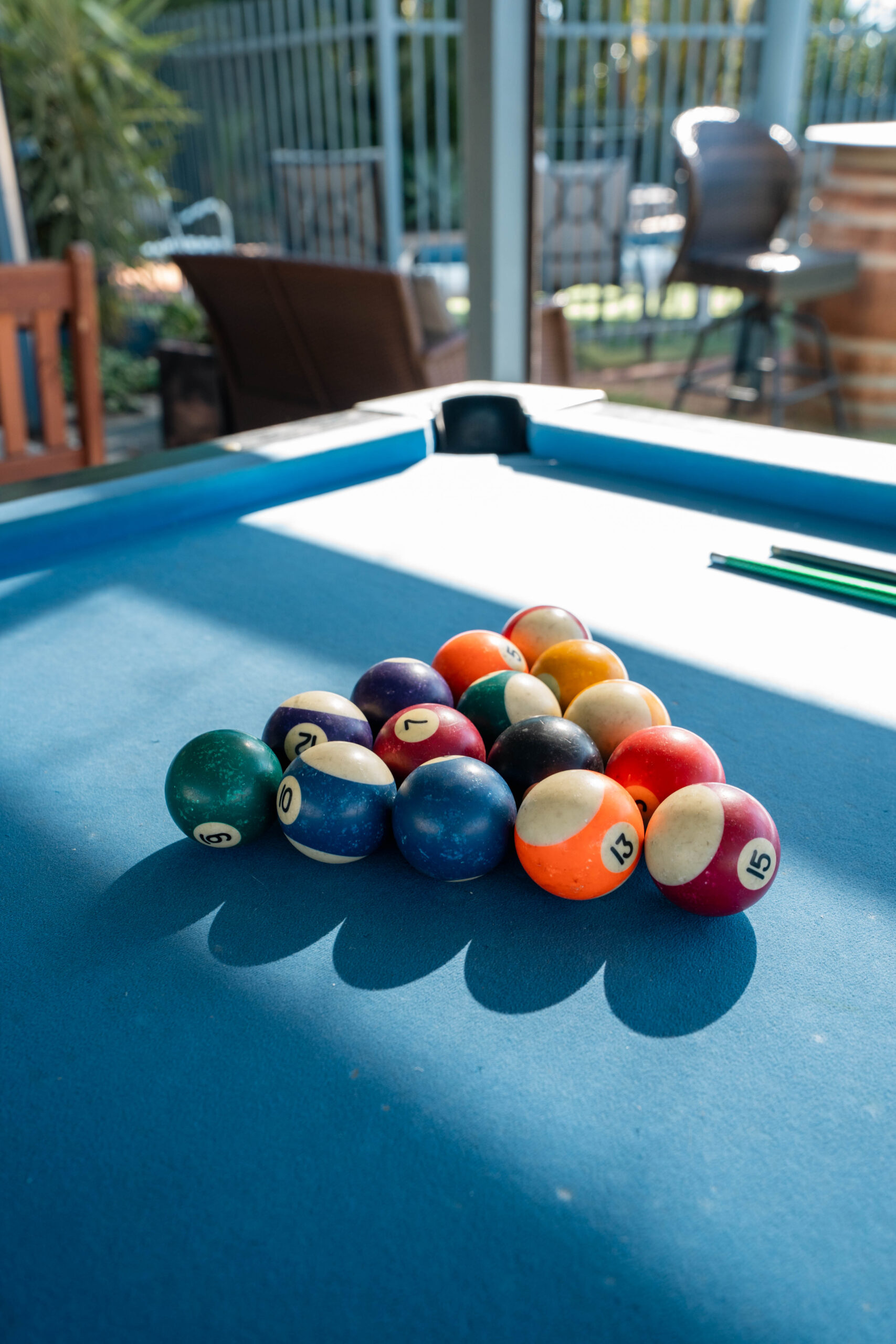 Close up of the undercover BBQ area, specifically the pool table area and the pool balls on a beautiful sunny day.